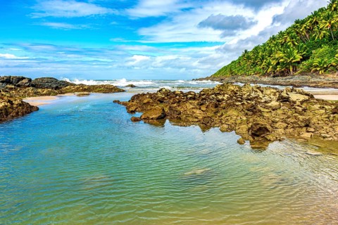 Rocks and water on a deserted beach on the southern coast of Bahia state, Brazil, Serra Grande,