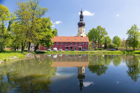 Baroque village church with reflection in the parish pond, Neschwitz, Upper Lusatia, Saxony,