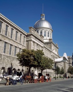 Bonsecours Market and horse-drawn carriage rides parked on Rue De la Commune street in summer, Old