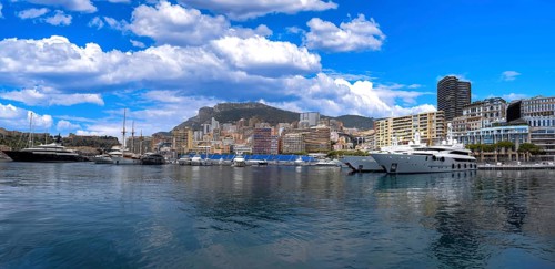 France, French Riviera, Monte Carlo view from marina with luxury yachts and cars in Monaco bay