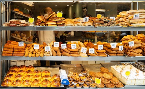 Variety of cakes and snacks on display in bakery shop, city of Porto, Portugal