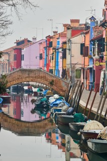 Colorful houses beside the waterway at 'Fondamenta di Terranova' with boats lying in the water on