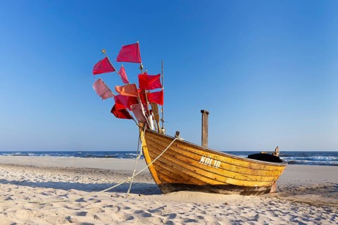 Traditional wooden fishing boat on the beach along the Baltic Sea at Stubbenfelde, Loddin on the