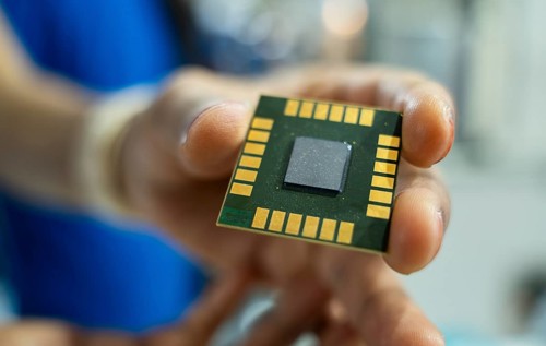 A person shows a computer chip in a stall, during The Advantage Assam 2.0 Investment Summit in