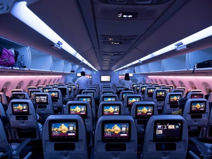 Aircraft interior, empty cabin, seats with screens, Qatar Airways