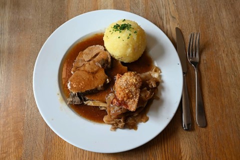 Roast pork with dumpling and crust served in a Franconian restaurant, Bavaria, Germany