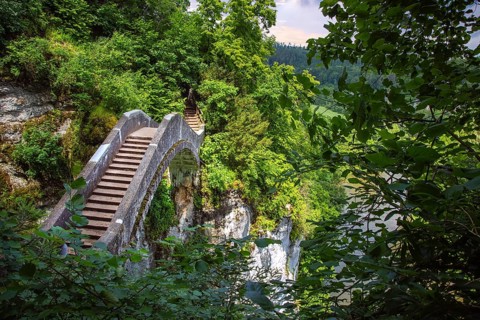 The narrow Teufelsbrücke bridge near Inzigkofen winds its way through lush greenery and steep