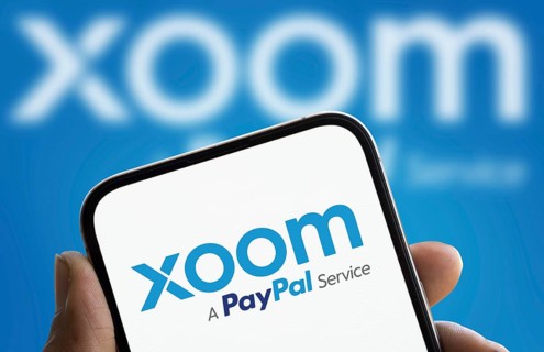 xoom logo is displayed on smartphone. Xoom Corporation is an electronic funds transfer and