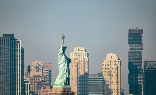 A clear view of the Statue of Liberty standing prominent against the backdrop of New York City's