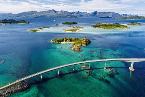 Sommaroy Bridge connecting Kvaloya Island to Sommaroy Island, small islands, mountain range in the