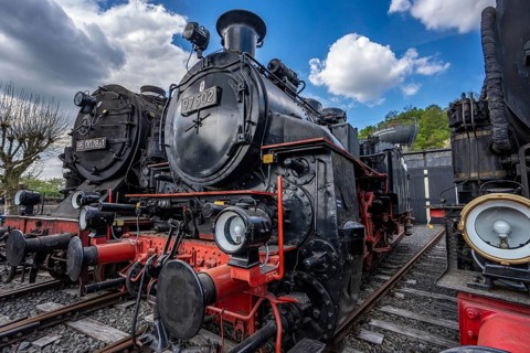 Ring locomotive shed with many historic steam locomotives in the Bochum Railway Museum, museum days