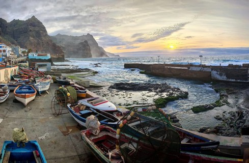 Harbour view with traditional fishing boats and sunset over the sea, romantic harbor scene, Ponta