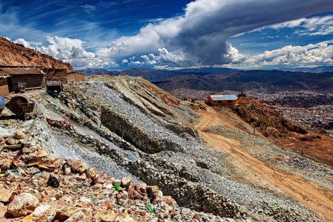 Falling scree slope with buildings and wide clouds on the horizon, The silver mines near Potosi on
