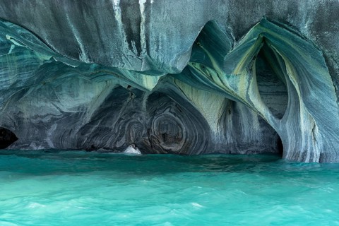 Marble caves with curved rock formations over turquoise water, Capillas de Mármol, General Carrera