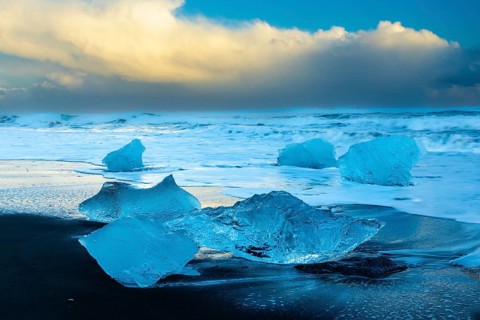 Ice chunks on the black beach, lava beach, glacier ice, sea, winter, sunset, Diamond Beach