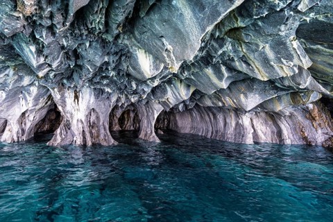 Marble caves (Cuevas de Mármol) with eroded marble formations over turquoise-coloured water, Lago