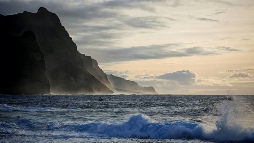 Evening light, twilight, dramatic coastal landscape, steep cliffs, silhouette of mountain