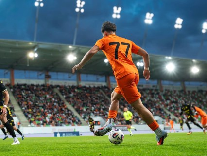 Football player dribbles during the match at the stadium in Lubin, Poland