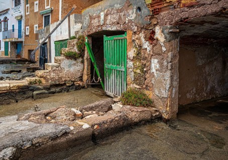 Old and dilapidated boat shelters that are not being used, old port area in Portocolom on the east