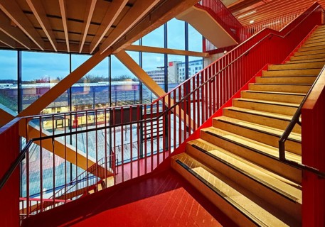 Staircase with signal red color scheme in seminar building H of Bochum University in the evening