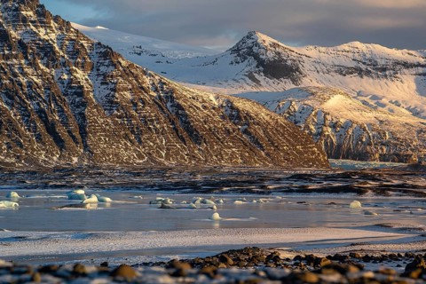 A stunning Icelandic winter scene captures the snow-capped peaks of Skaftafell scattered across a