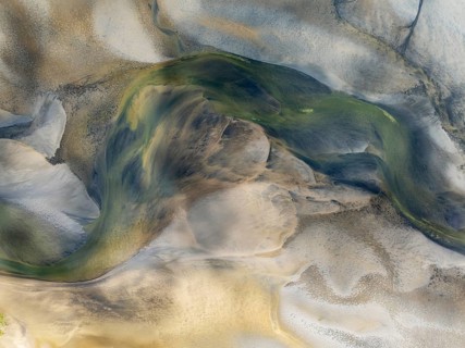Streams and marshes at low tide in the wetlands of the Walvis Bay lagoon. In the distance Greater