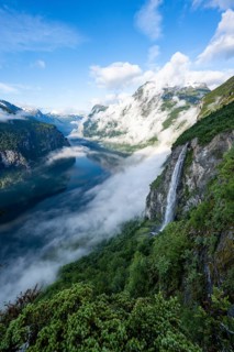 Gjerdefossen waterfall, at Ørnesvingen viewpoint, atmospheric clouds over the fjord in the morning