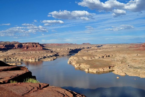 A river landscape in a rocky desert region under blue sky with clouds, Lake Powell, Arizona, USA