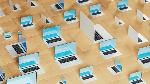 Numerous laptops arranged on a geometric backdrop illustrate the connection between technology and