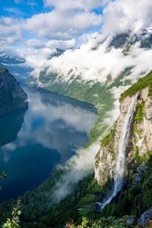 Gjerdefossen waterfall, at Ørnesvingen viewpoint, atmospheric clouds over the fjord in the morning