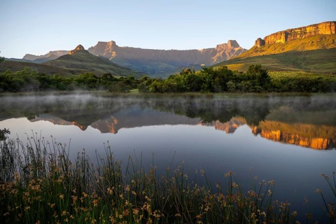 Sunrise, amphitheatre with reflection in the lake, Royal Natal National Park, Drakensberg Mountains