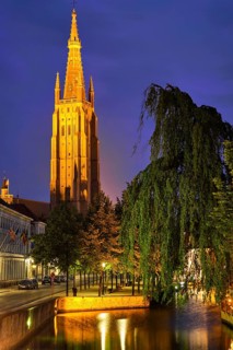 Church of Our Lady and canal illuminated in the night. Brugge Bruges, Belgium