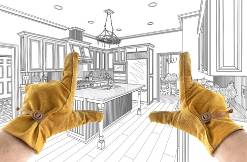 Male Contractor Hands Framing Over Custom Kitchen Design Drawing