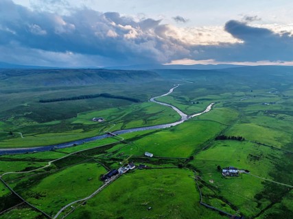 Forest in Teesdale over River Tees from a drone, North Pennines AONB, County Durham, England,