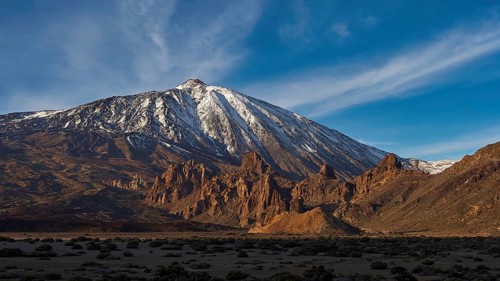 Llano de Ucanca, impressive snow-covered volcanic landscape with distinctive rocks and blue sky,