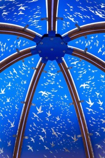 Close-up of backlit blue tinted plexiglass and curved wood panels canopy decorated with white flock