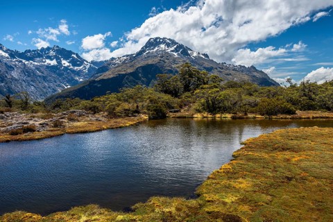Mountain landscape with lake on the Key Summit Track hiking trail. View of Mount Crosscut and Mount