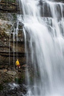 Adventure, Little hiker under large Cascata di Mezzo waterfall, long exposure, Vallesinella,