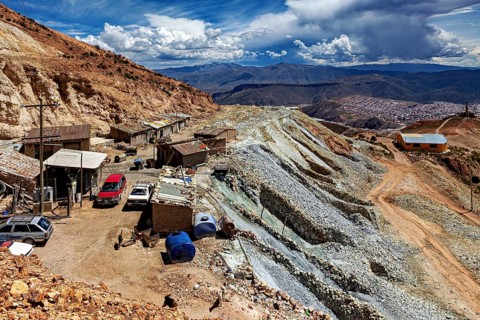 Small settlement on a mountainside surrounded by boulders and wide skies, The silver mines near