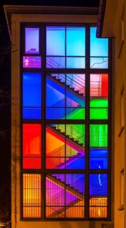 View through the windows of a brightly lit staircase. Frankfurter Mainova AG building, city center,