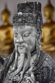 Stone statue of a Chinese warrior, guardian, Wat Pho, Temple of the Reclining Buddha, Bangkok,