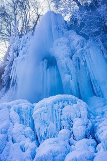 Urach waterfall full of bizarre ice formations frozen at winter temperatures, Bad Urach, Swabian
