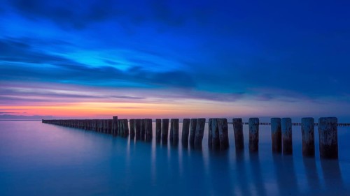 Sunset at beach of Baltic sea spa Nienhagen with breakwater groin, Baltic Sea, Mecklenburg-Western