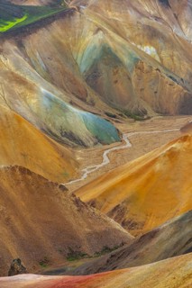 Small river between colourful rhyolite mountains, volcanic landscape, erosion landscape, view from