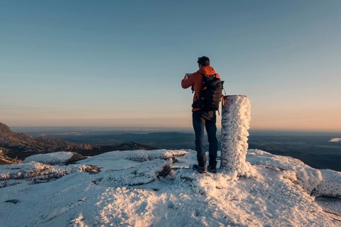 A stunning snowy view at Siete Picos, part of the Guadarrama Mountains in Madrid. A hiker stands on