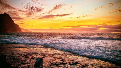 Warm sunset with golden reflections at the sea and visible cliffs, romantic, Ponta do Sol, Santo