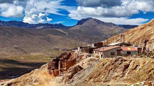 Mountainous landscape with buildings and wide sky under dramatic clouds, The silver mines near