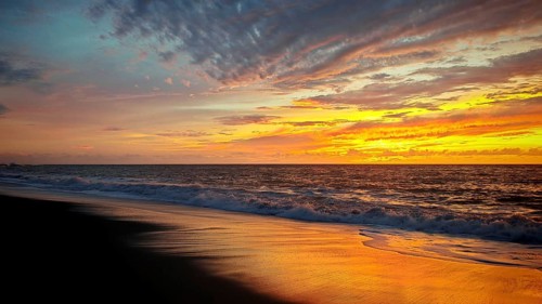 Romantic sunset over the sea with warm colors and calm water, Tarrafal de Monte Trigo, Santo Antao,
