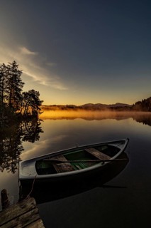 Boats in the autumnal Schmutter Weiher in the Allgäu near the municipalities of Halblech,