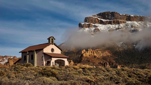 Ermita de las Nieves, small church in front of a mountain landscape with clouds, Teide, Parque